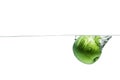 Green apple falling water on white background. Royalty Free Stock Photo