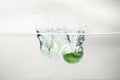 Green apple falling water on white background. Royalty Free Stock Photo