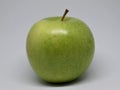 Green apple in the foreground on white background