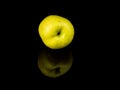 Green apple fruit on a black glass background with reflection Royalty Free Stock Photo