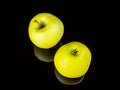 Green apple fruit on a black glass background with reflection Royalty Free Stock Photo