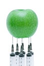 Green apple with inserted syringe Royalty Free Stock Photo