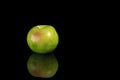 Green apple isolated on black background with reflection. Royalty Free Stock Photo