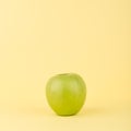 Green Apple isolated on Yellow Background. Clean & Fresh. Copy Space. Royalty Free Stock Photo