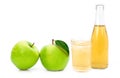 glass of apple cider vinegar and green granny smith apples isolated on white . Royalty Free Stock Photo