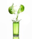 Green apple juice splashing with its fruits Royalty Free Stock Photo