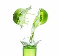 Green apple juice splashing with its fruits Royalty Free Stock Photo