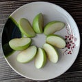 Green apple Malus domestica slices on white plate isolated on wallpaper background closeup. Royalty Free Stock Photo