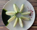 Green apple Malus domestica slices on white plate isolated on wallpaper background closeup. Royalty Free Stock Photo