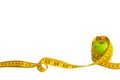 Green apple and measuring tape  with centimeters and inches isolated on white background. Royalty Free Stock Photo