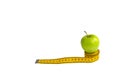 Green apple and measuring tape  with centimeters and inches isolated on white background Royalty Free Stock Photo
