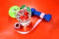 A green apple with a measuring tape, dumbbells. A delicious home made drink with fresh berries in a glass. Royalty Free Stock Photo