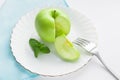 green apple and mint on a white plate Royalty Free Stock Photo