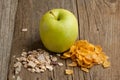 Green apple with muesli and corn-flakes Royalty Free Stock Photo