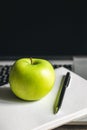 Apple near laptop at workplace, healthy snack. Royalty Free Stock Photo