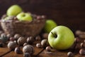 Walnuts with green apples mixed with a wicker basket Royalty Free Stock Photo
