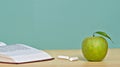 Green apple and open book Royalty Free Stock Photo