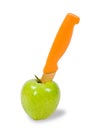 Green apple and orange knife Royalty Free Stock Photo