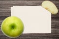 Green Apple and and paper on wood background Royalty Free Stock Photo