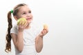 Green apple and potato chips, healthy and unhealthy food for kids, little girl chooses apple over chips. Royalty Free Stock Photo