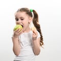 Green apple and potato chips, healthy and unhealthy food for kids, little girl chooses apple over chips. Royalty Free Stock Photo