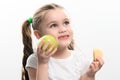 Green apple and potato chips, healthy and unhealthy food for kids, little girl chooses apple over chips. Royalty Free Stock Photo