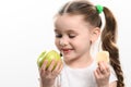 Green apple and potato chips, healthy and unhealthy food for kids, little girl chooses apple over chips. Royalty Free Stock Photo