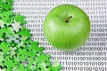 green apple and puzzles on a binary code Royalty Free Stock Photo