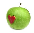 Green apple with red heart on it Royalty Free Stock Photo