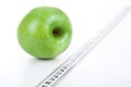 Green apple with a ruler Royalty Free Stock Photo
