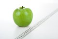 Green apple with a ruler Royalty Free Stock Photo