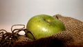 Green apple on a sacking