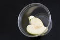 Green apple slice on plastic container. Dietary foods and weight loss concept