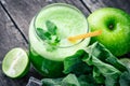 Green apple smoothie in glass and kale leaves on wooden table Royalty Free Stock Photo