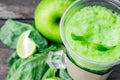 Green apple smoothie in glass and kale leaves on wooden table Royalty Free Stock Photo