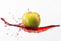 Green apple and splash of red juice on white background Royalty Free Stock Photo