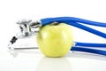 Green apple and stethoscope on white background Royalty Free Stock Photo