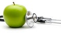 Green apple with stethoscope on white background fruit Royalty Free Stock Photo