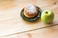 Green apple and sugar donut on the table, the dilemma of what to choose, the concept of healthy eating and lifestyle