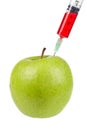 Green apple with syringe inserted Royalty Free Stock Photo
