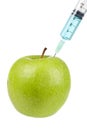 Green apple with syringe inserted Royalty Free Stock Photo