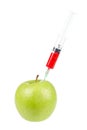 Green apple with syringe inserted Royalty Free Stock Photo