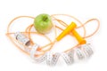 A green apple, tape measure and rope