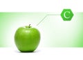 A green apple with a vitamin sign on a light background