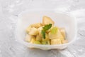 Green apple and mint leaf salad with condensed milk in food container Royalty Free Stock Photo