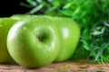 Green apple with water drop on wood table Royalty Free Stock Photo