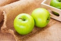 Green apple and wooden tray, filtered image