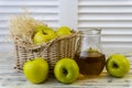 Green apples, basket with apples and jug with apple juice on wooden background Royalty Free Stock Photo