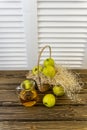 Green apples, basket with apples and jug with apple juice on wooden background Royalty Free Stock Photo