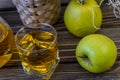 Green apples, basket with apples and jug with apple juice on wooden background Royalty Free Stock Photo